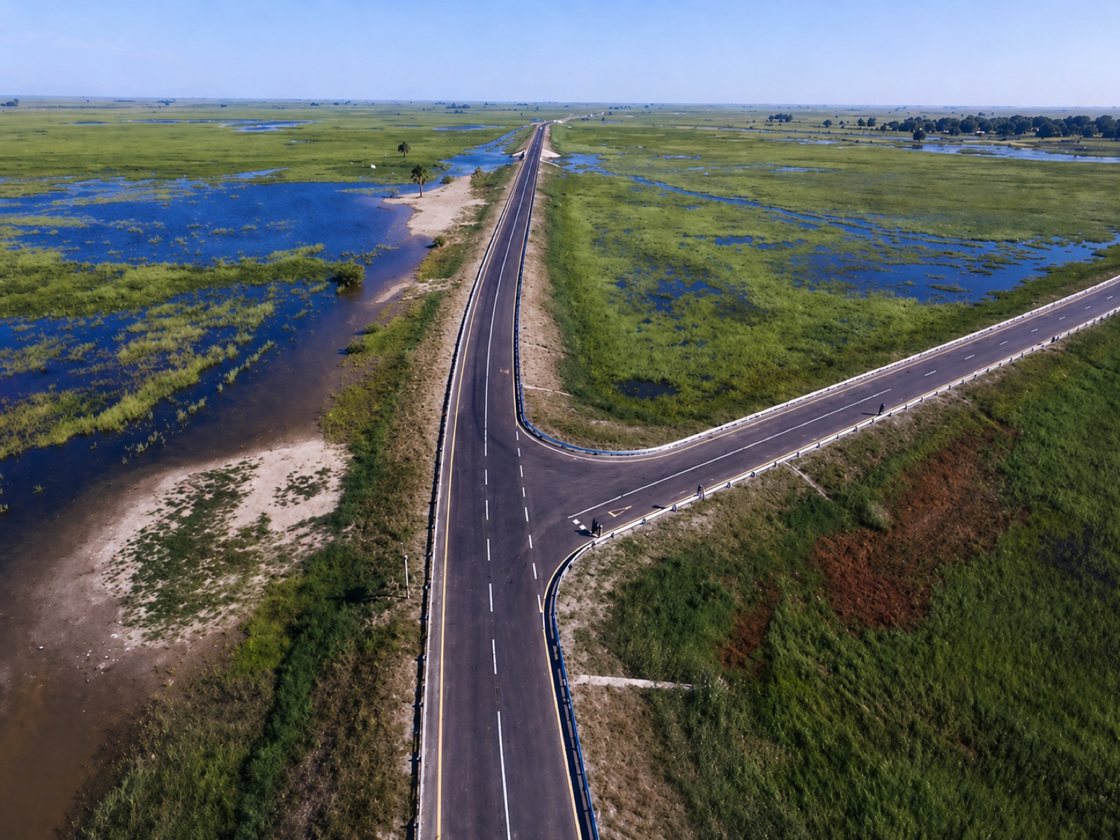 Aerial view of a road junction on the Mongu–Kalabo causeway, with seasonal floodwater visible across the surrounding plain.